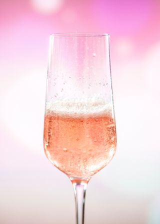 Champagne glass filled with pink champagne symbolizing you should celebrate what you're passionate about
