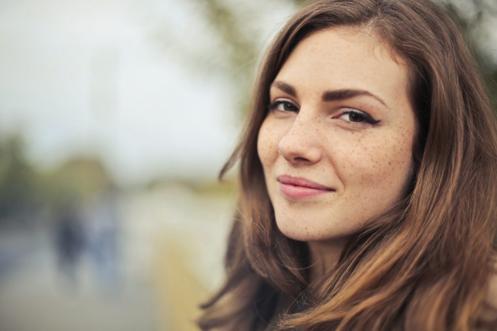 Woman staring confidently into camera symbolizing she has learned how to stop doubting herself