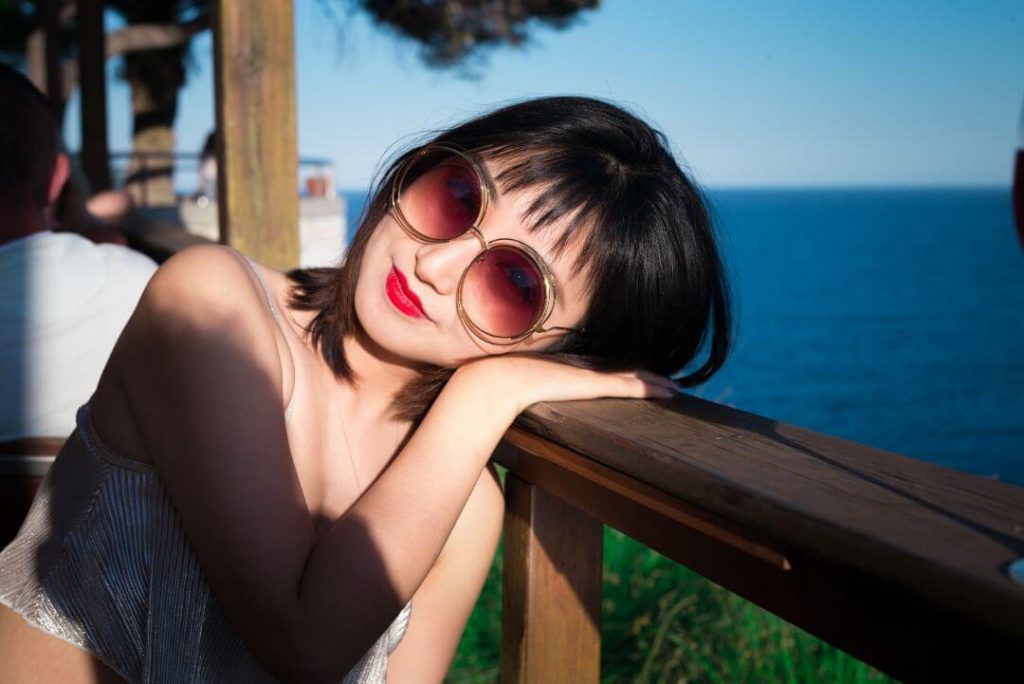 woman wearing rose colored glasses